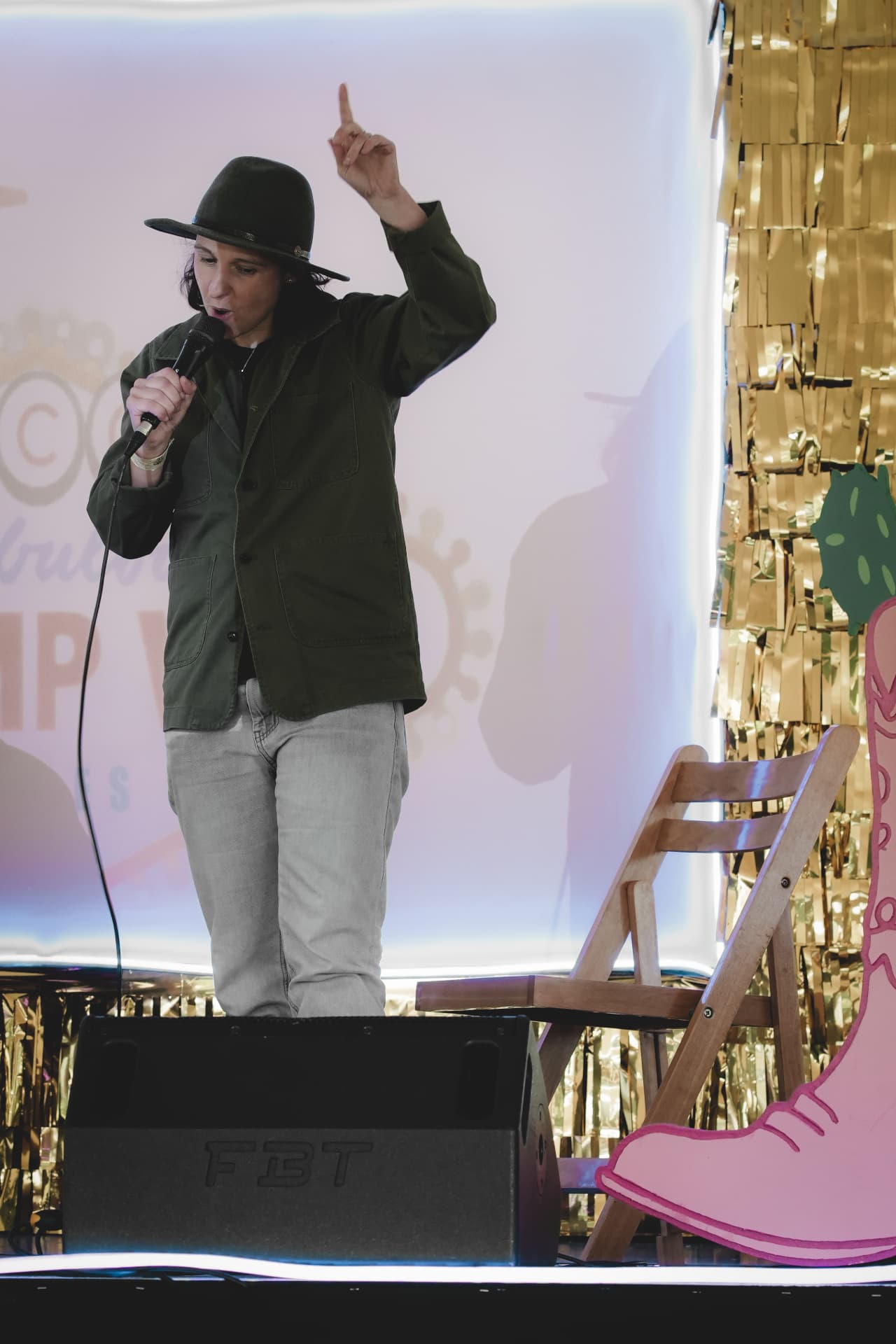 Michelle performing on stage with a microphone